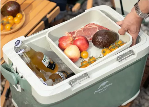 le Réfrigérateur portable vert avec de la boisson a l'intérieure